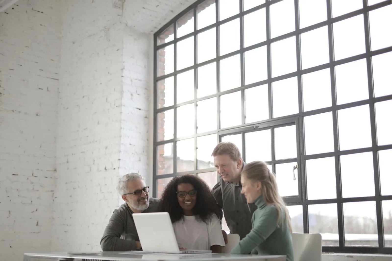 A team collaborating over a laptop